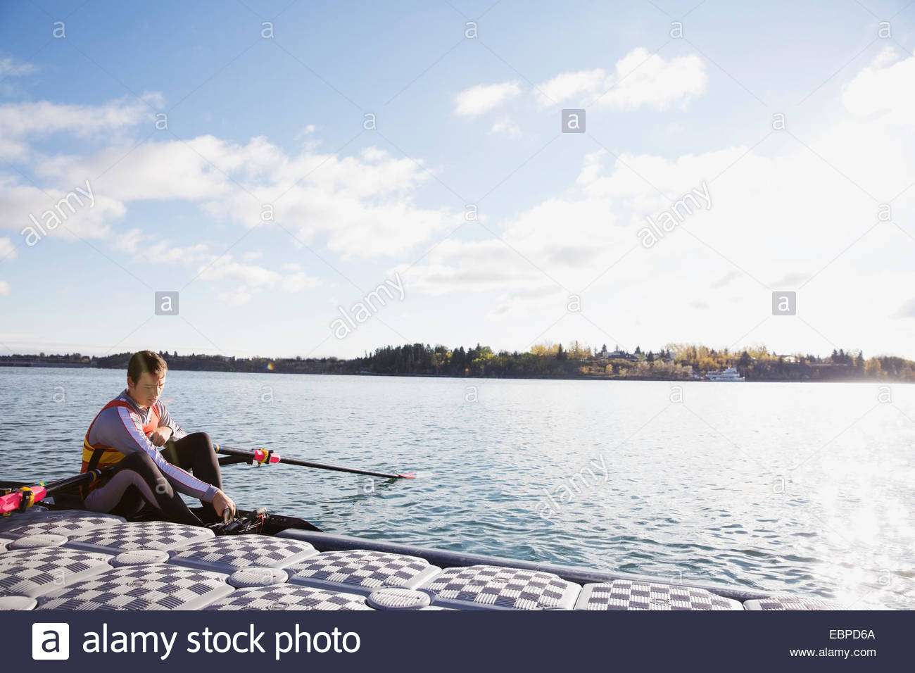 Rower in scull at waterfront Stock Photo