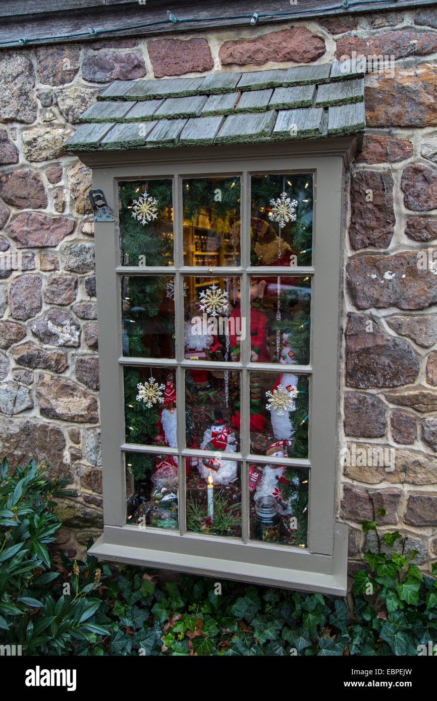 A small shop has its window decorated for the Christmas holiday. Stock Photo