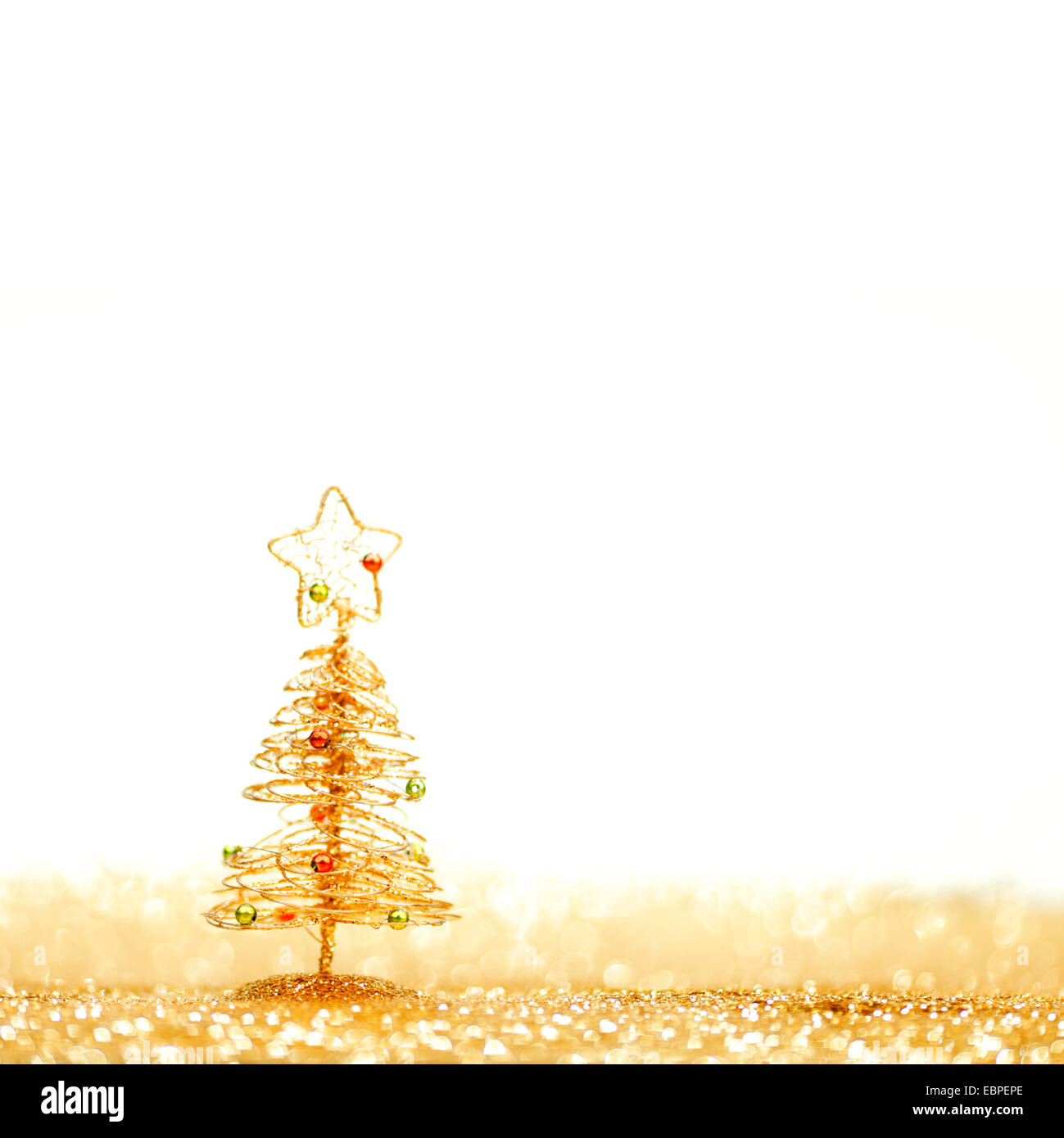Toy golden decorative Christmas tree on glitter background Stock Photo ...