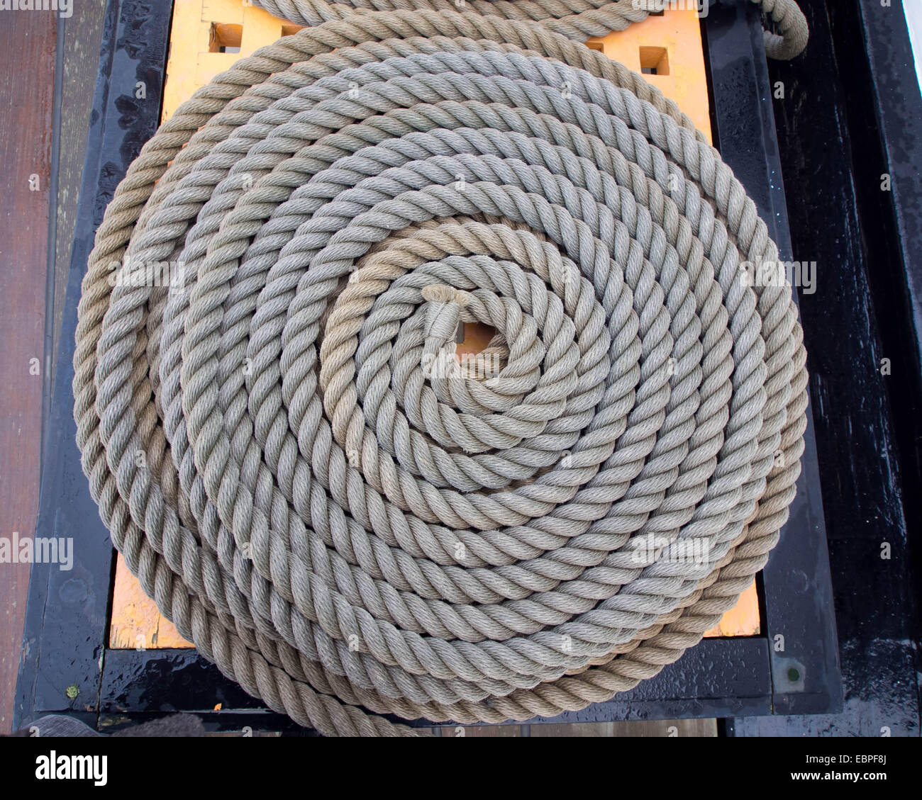 A coiled down length of natural fibre rope Stock Photo