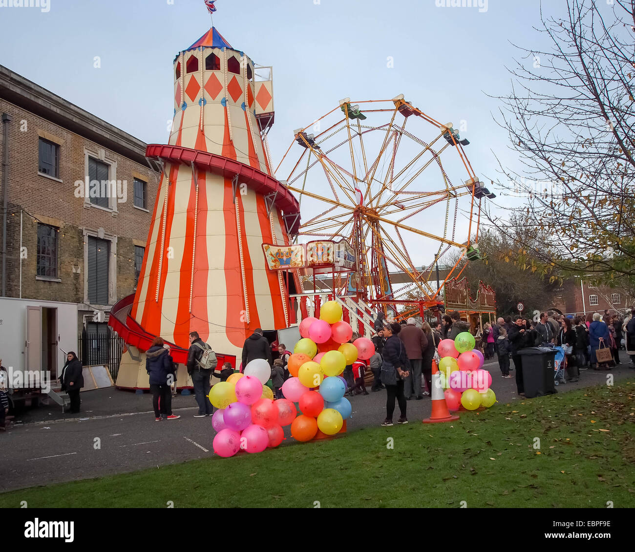 A victorian Helter Skelter and ferris wheel at a traditional fairground Stock Photo
