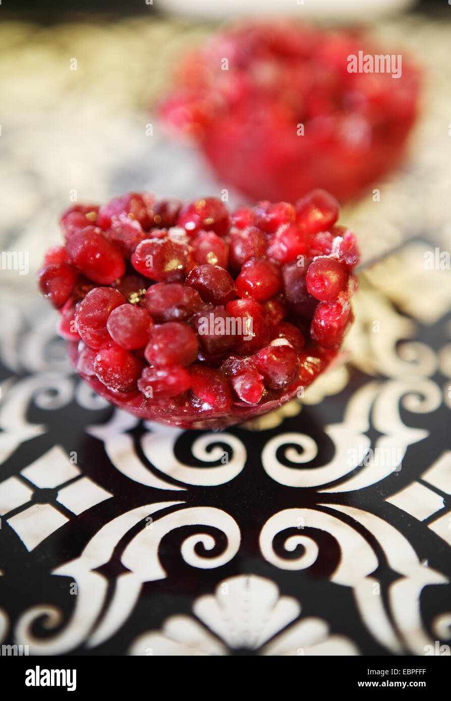 pomegranate red on a black and white tray Stock Photo