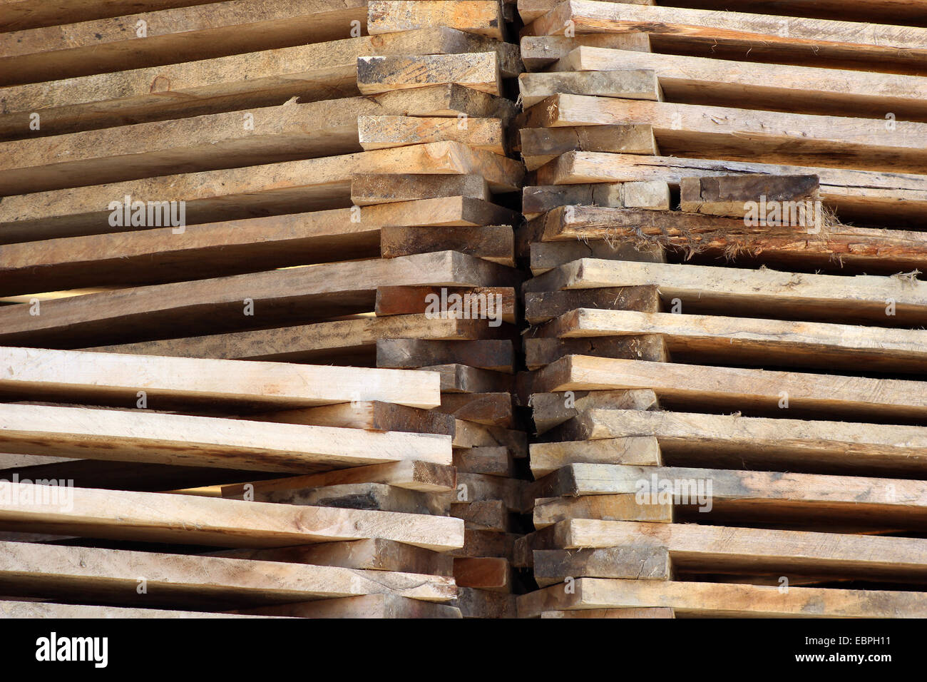 Stacked cut wood at an outdoor sawmill in Cotacachi, Ecuador Stock