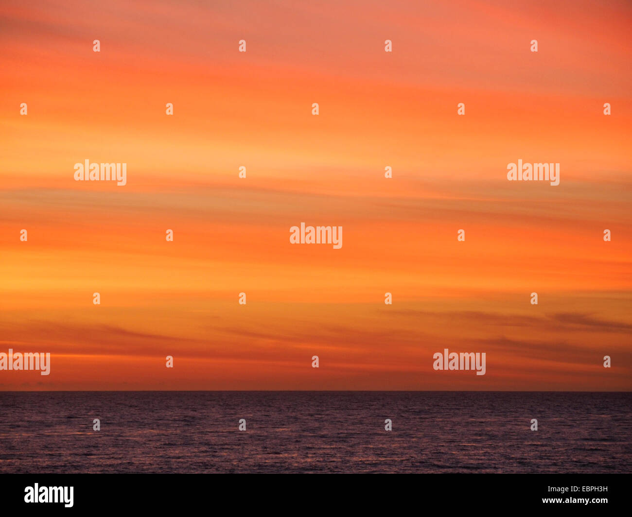 Yellow Red Orange Pacific Ocean Sunset Sky Stock Photo