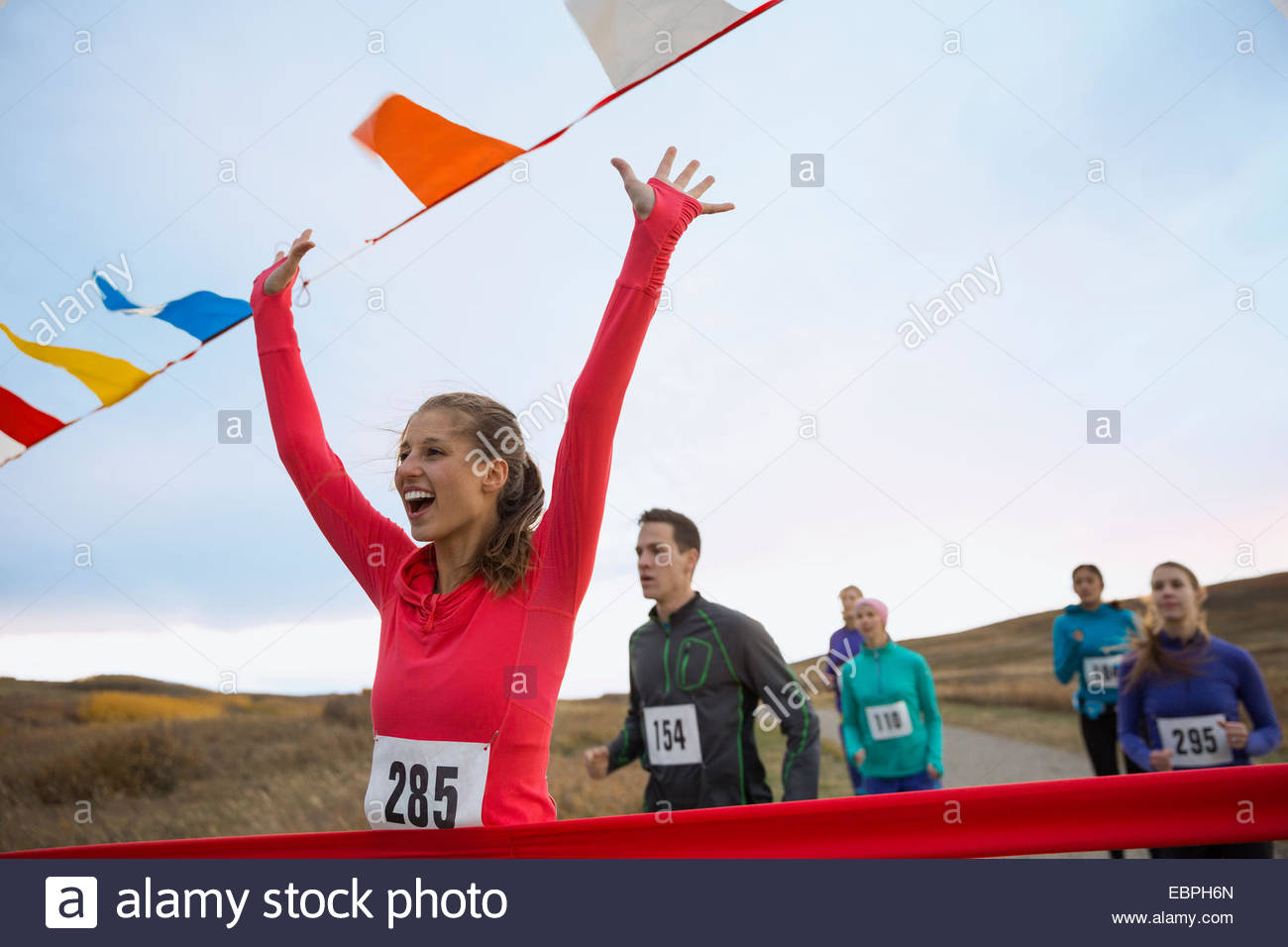 Cheering runner approaching finish line Stock Photo