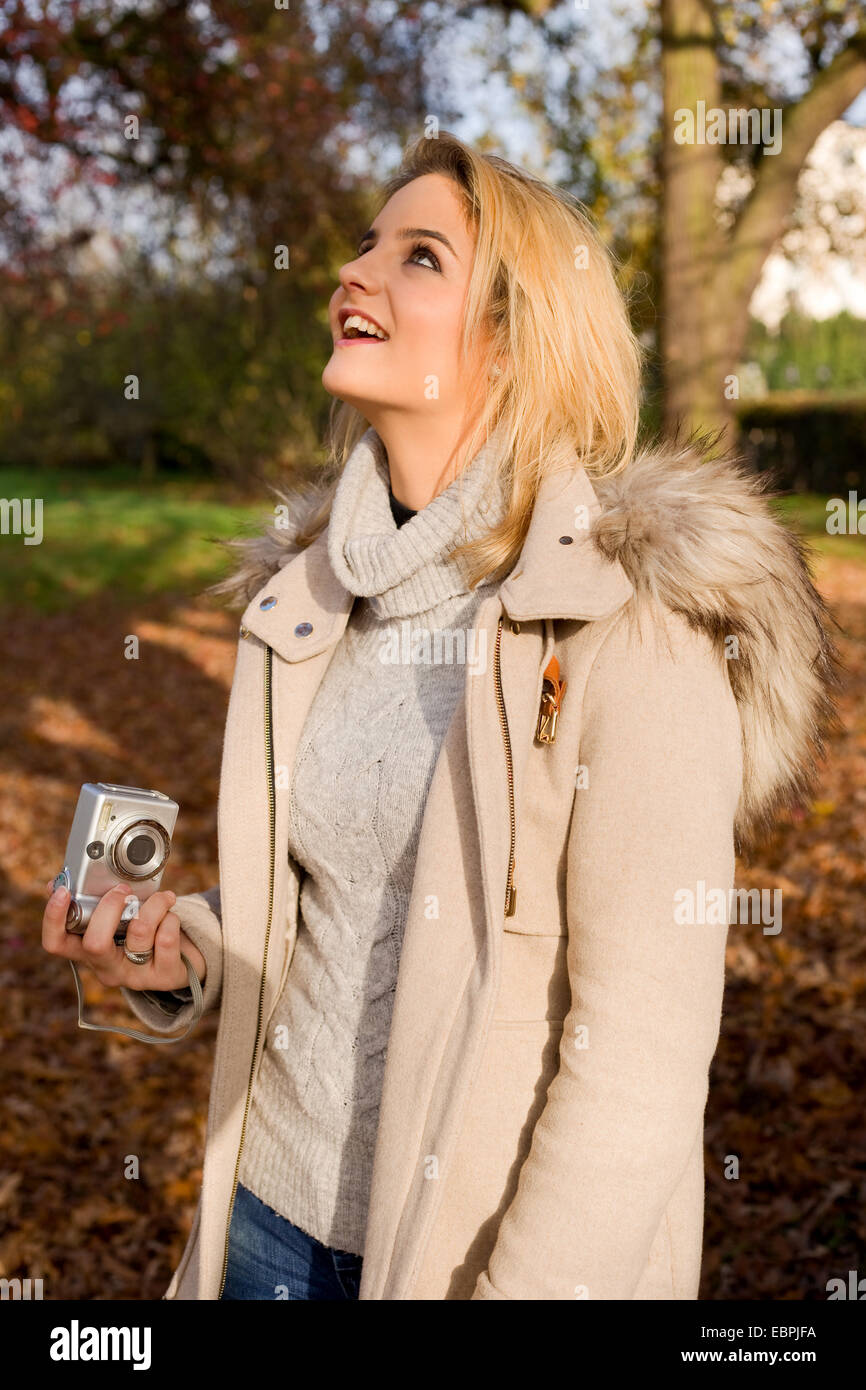 a happy young woman holding a camera Stock Photo - Alamy