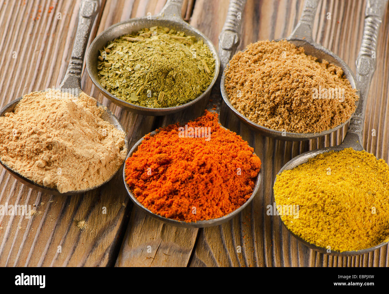 Assortment of powder spices on spoons. Selective focus Stock Photo - Alamy