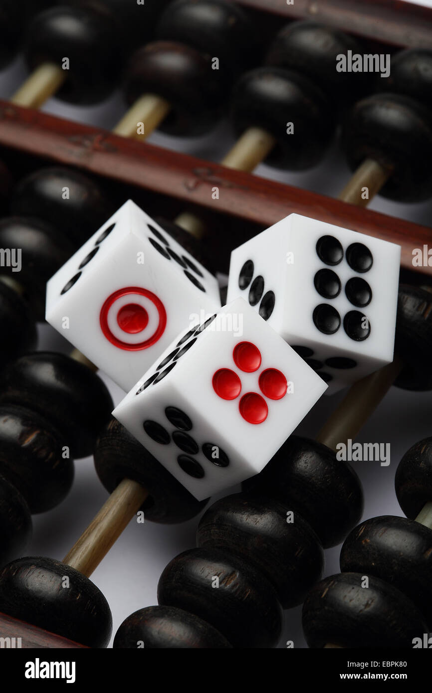 three dice on abacus are symbolic of gambling Stock Photo