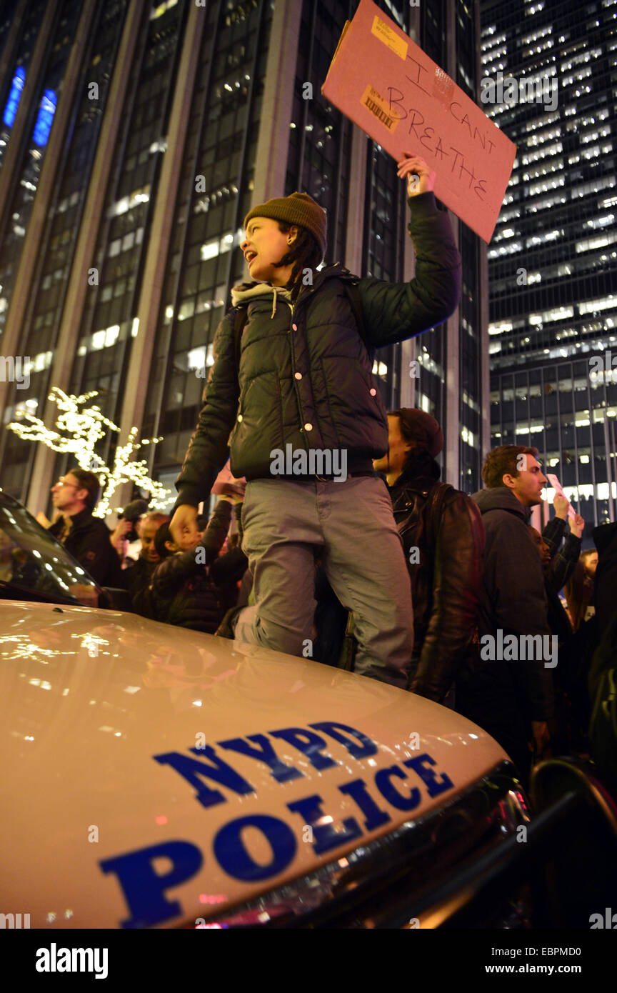 New York, USA. 3rd Dec, 2014. A protestor attends a rally at midtown ...
