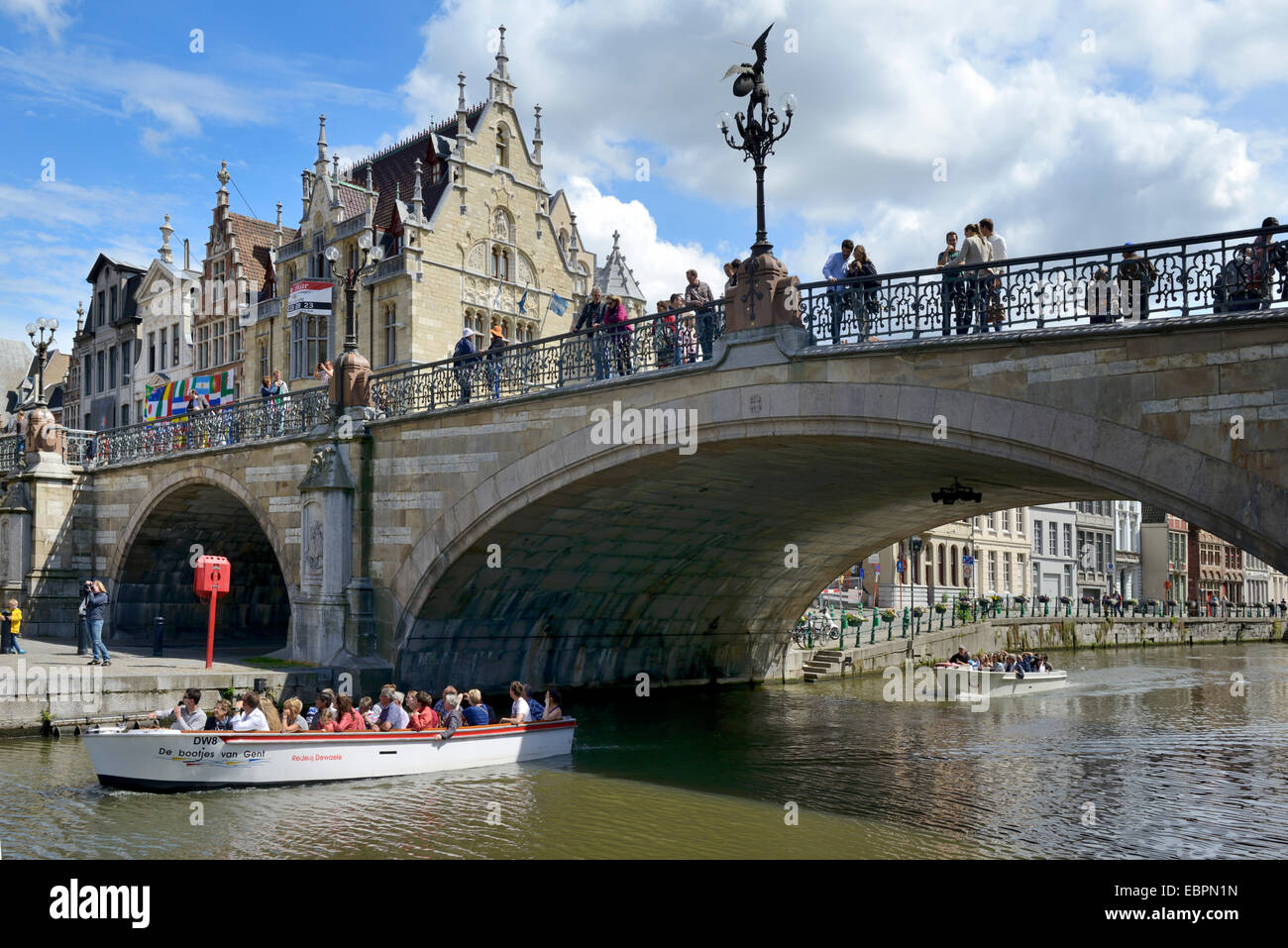 Pleasure boat on the river passing under St. Michaels bridge, Ghent, Flanders, Belgium, Europe Stock Photo