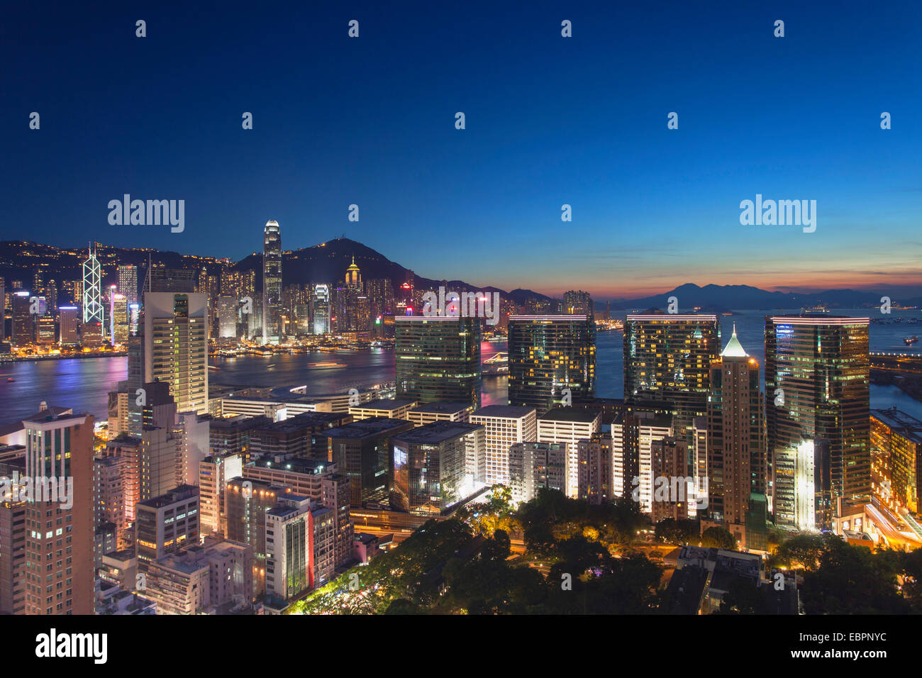 View of Hong Kong Island and Tsim Sha Tsui skylines at dusk, Hong Kong, China, Asia Stock Photo