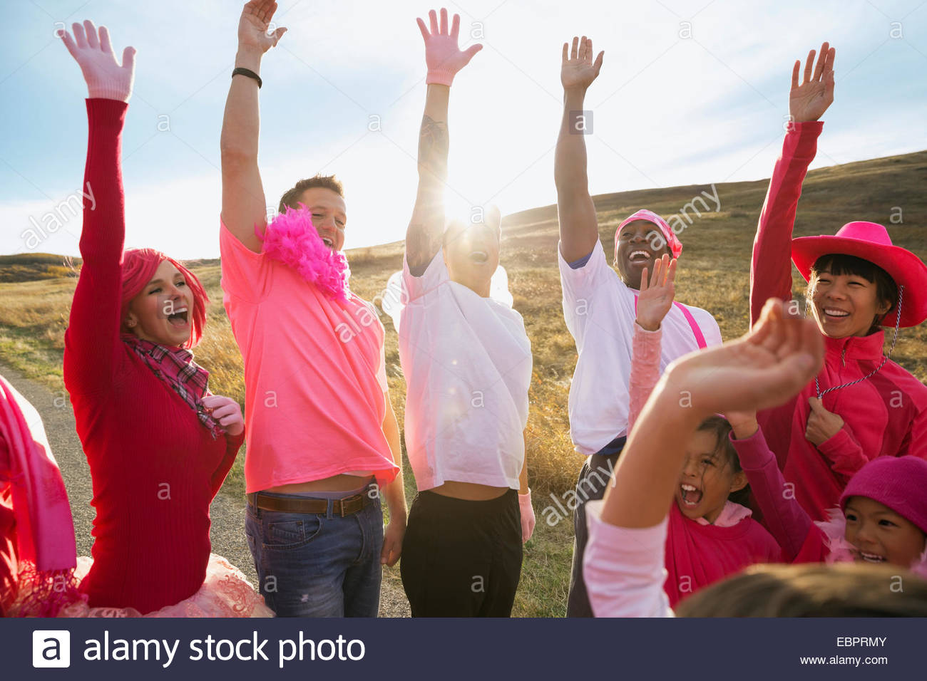 Group in pink cheering at charity race Stock Photo
