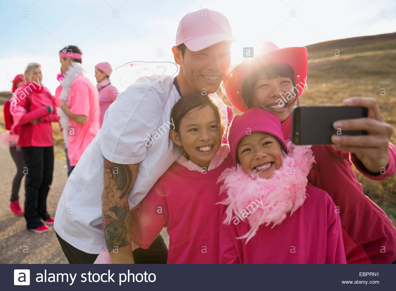 Family in pink taking selfie at charity race Stock Photo