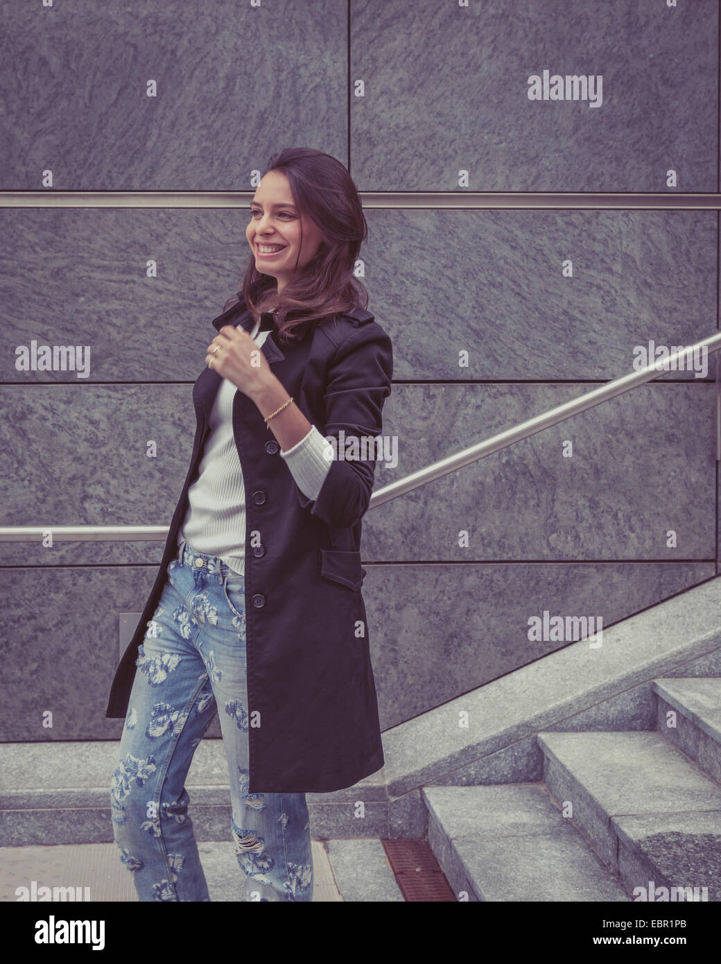 Pretty girl with long hair poses in the city streets Stock Photo - Alamy