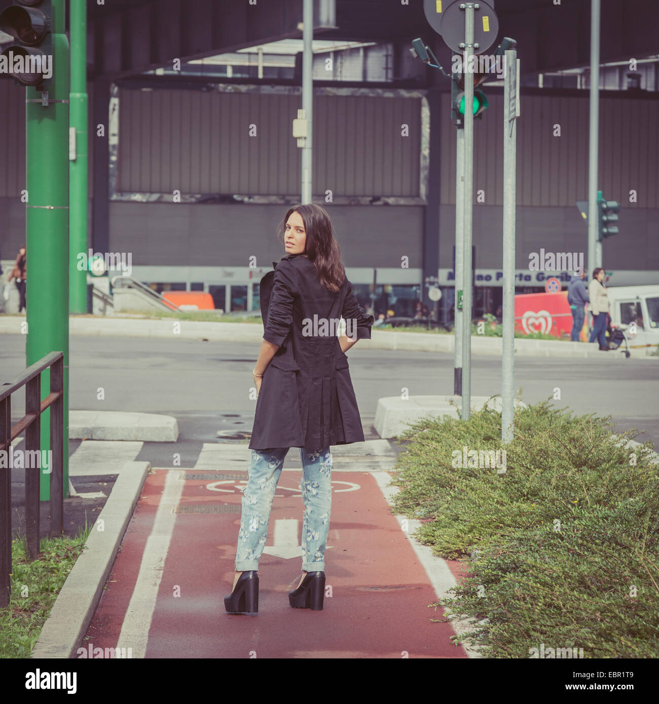 Pretty girl with long hair poses in the city streets Stock Photo - Alamy