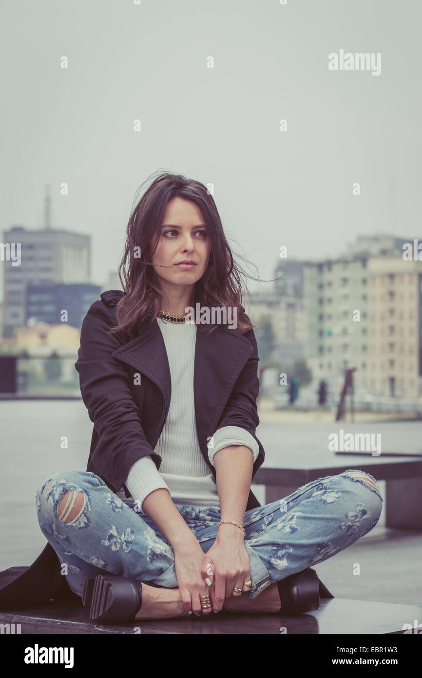 Pretty girl with long hair poses in the city streets Stock Photo - Alamy