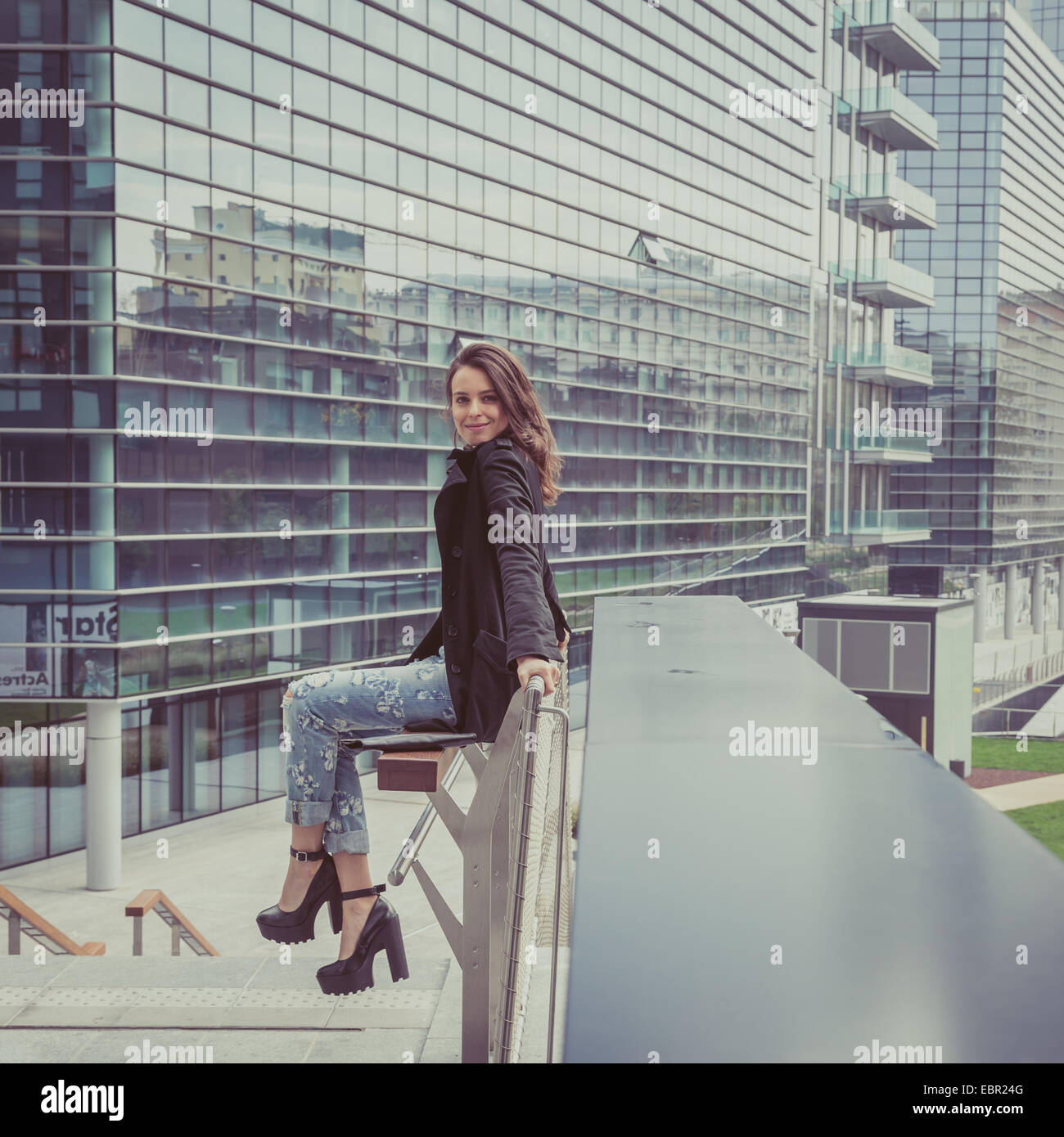 Pretty girl with long hair poses in the city streets Stock Photo - Alamy