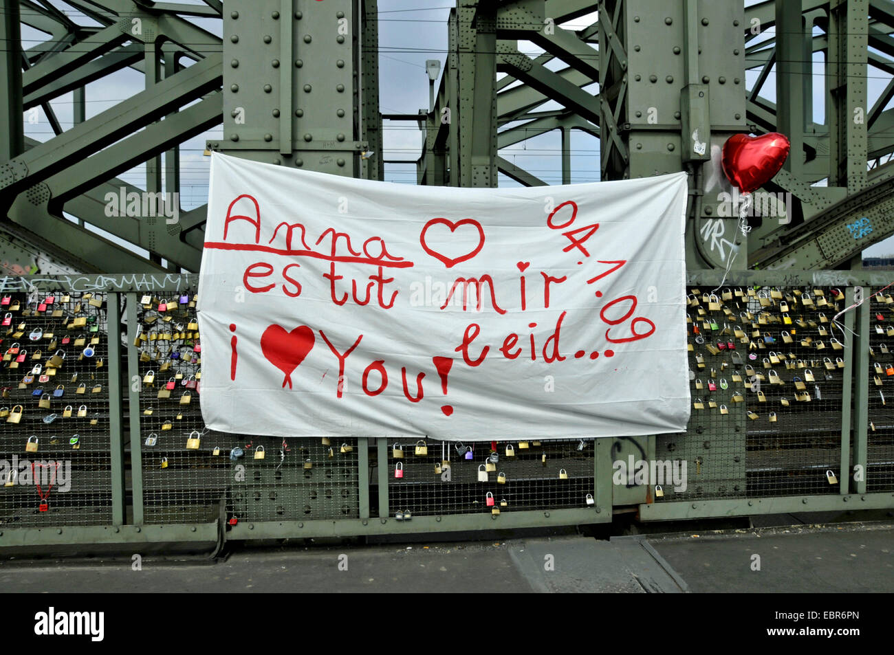 drapery with an 'Excuse me, Anna' at bridge Hohenzollernbruecke, Germany, North Rhine-Westphalia, Cologne Stock Photo