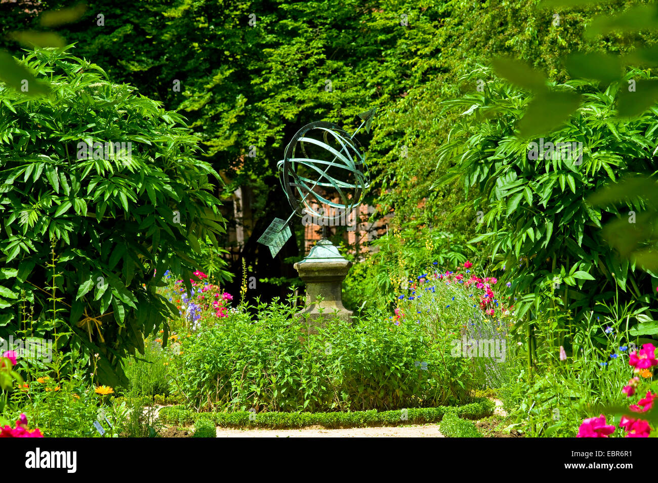 old copper sun dial in a rural garden, Germany Stock Photo