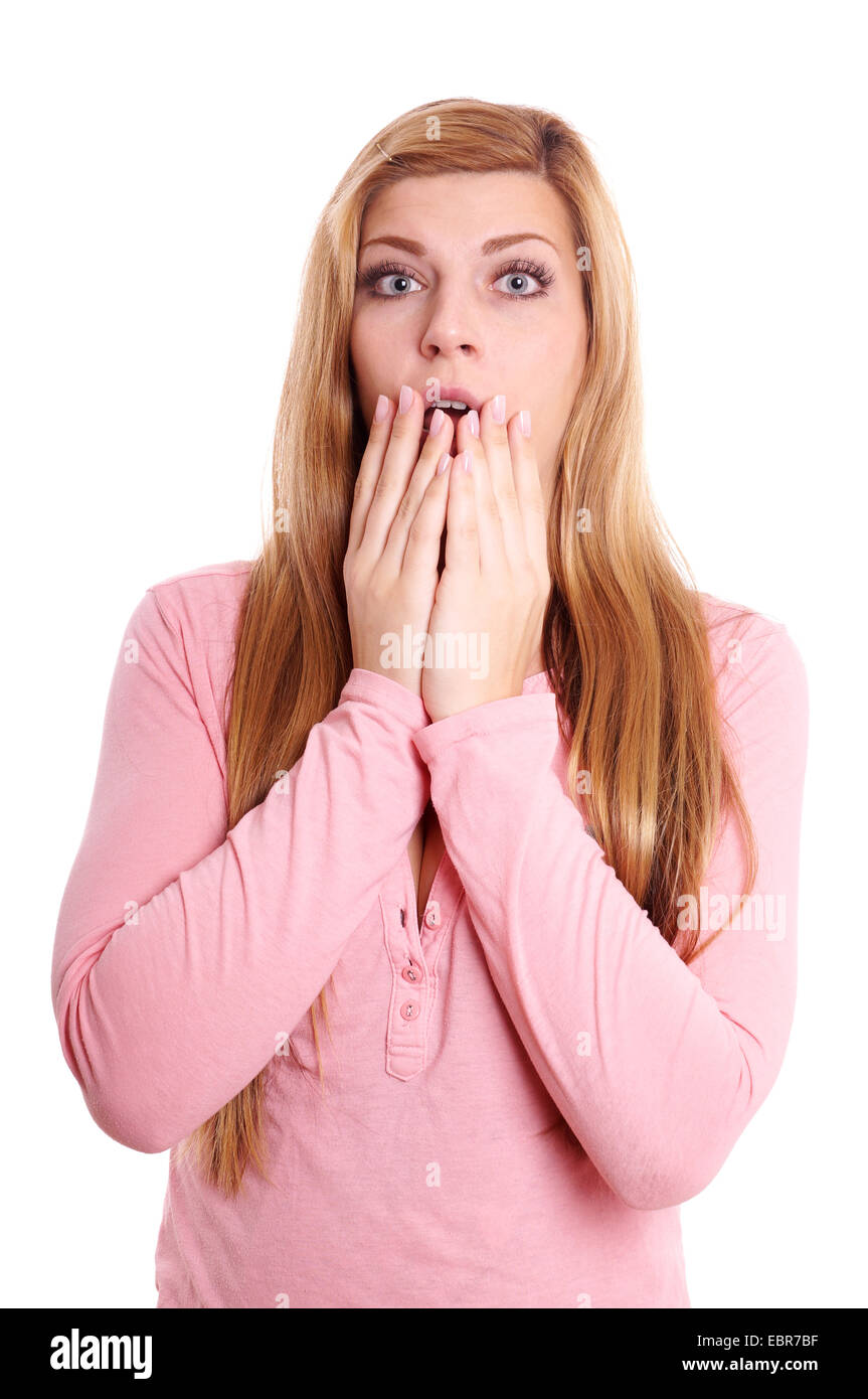 shocked young woman covering her open mouth with both hands Stock Photo