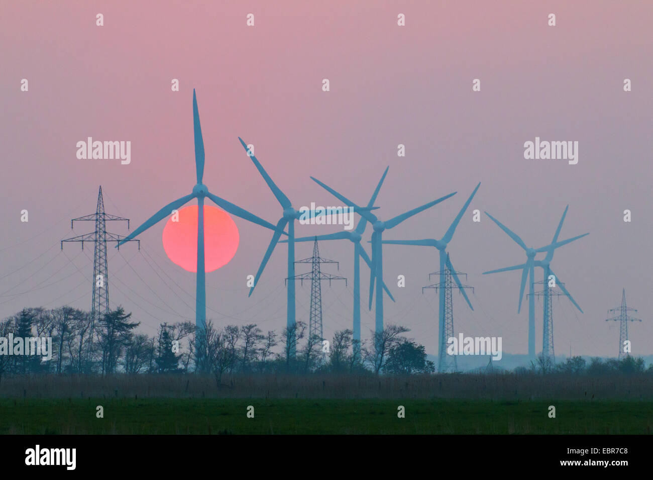 wind power stations at sunrise , Germany, Lower Saxony, Ostermarsch Stock Photo