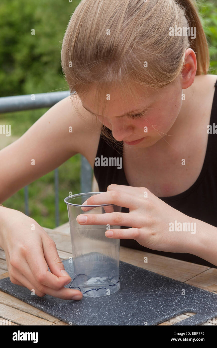 teenage girl tinkering a loupe, Germany Stock Photo