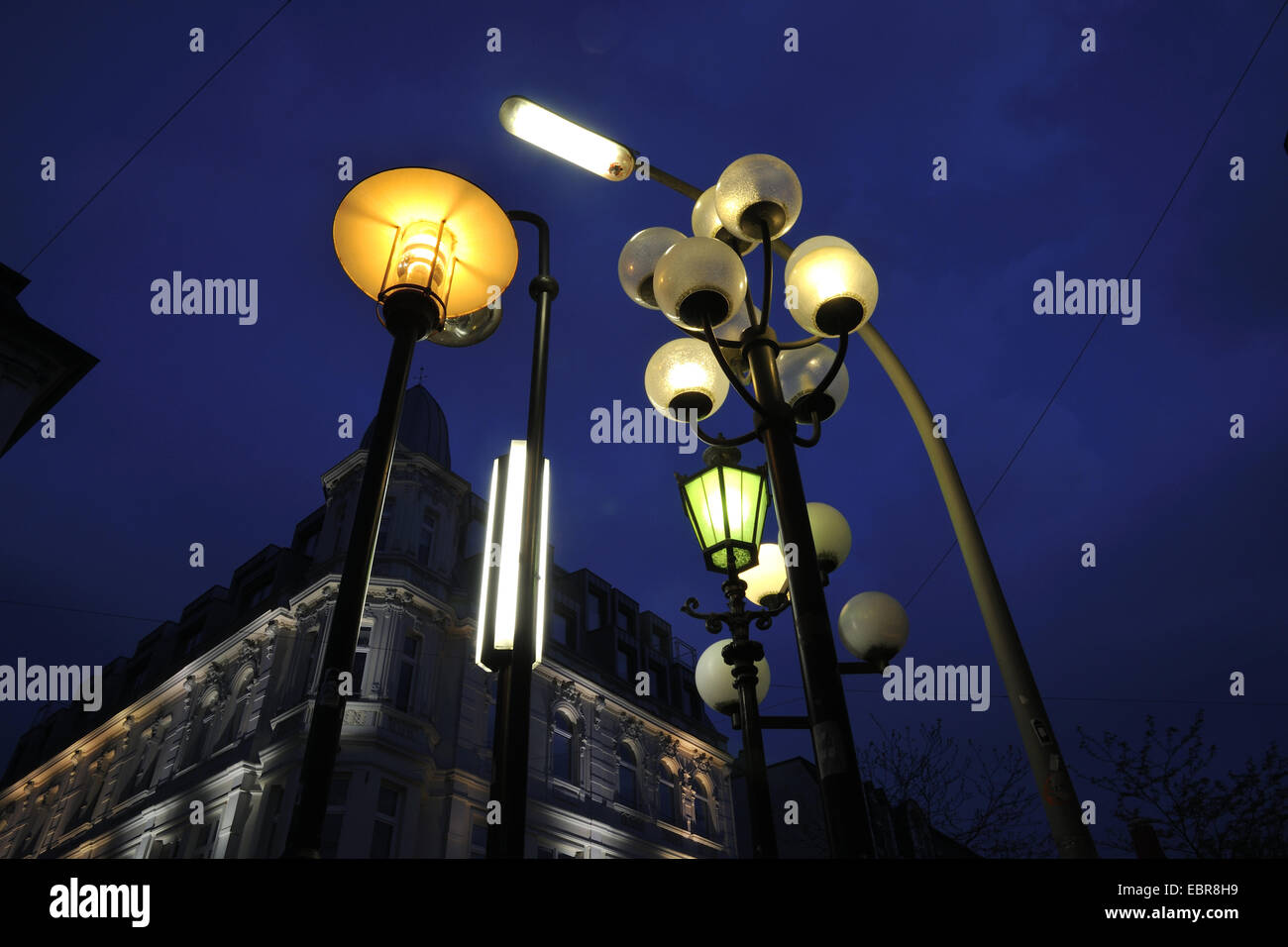different illuminated street lamps in the morning mood, Germany, North Rhine-Westphalia, Ruhr Area, Herne Stock Photo