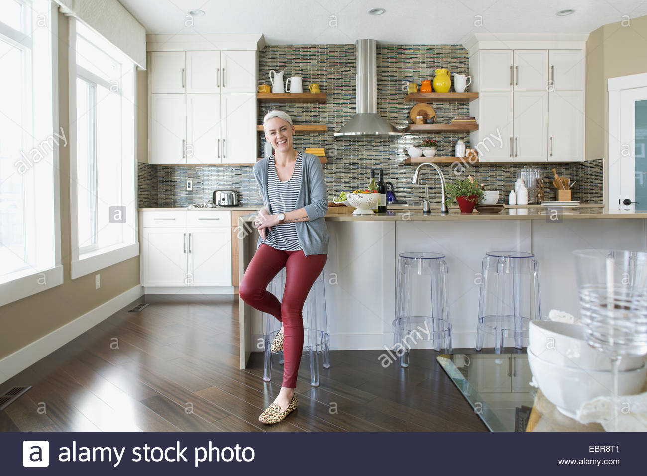Portrait of smiling woman in kitchen Stock Photo