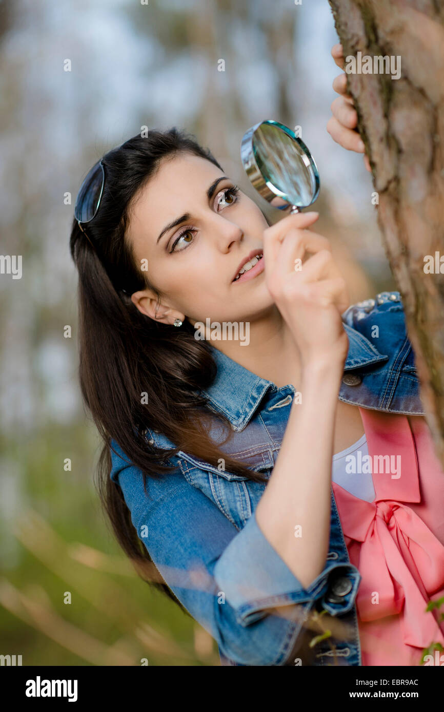 woman looking at tree bark through a magnifying glass Stock Photo Alamy
