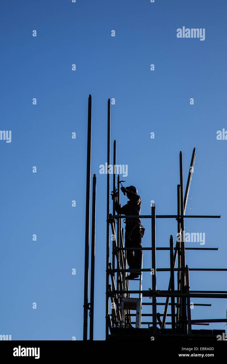 silhouette of construction worker with hammer on scaffolding Stock ...