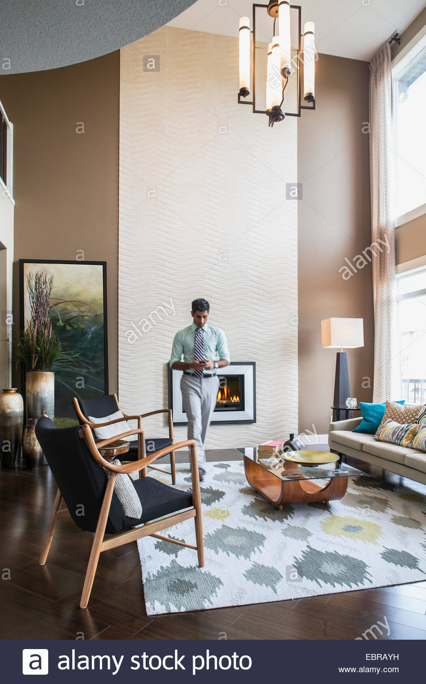 Man walking in modern living room Stock Photo