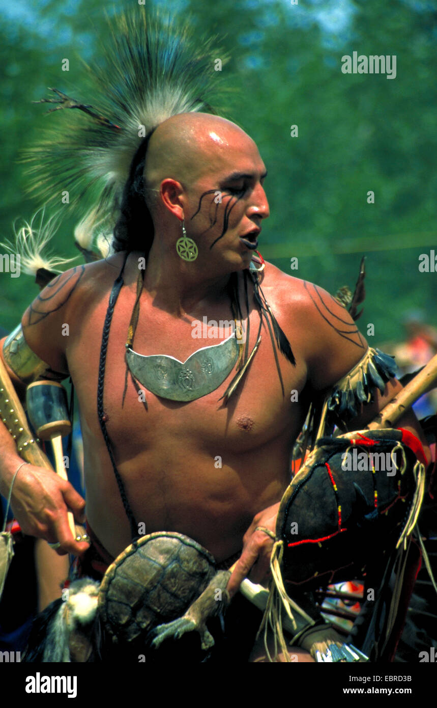 mohican with typical headdress of feathers and face painting at the pow wow in the Kahnawake reservation, Canada, Queebec, Montreal Stock Photo