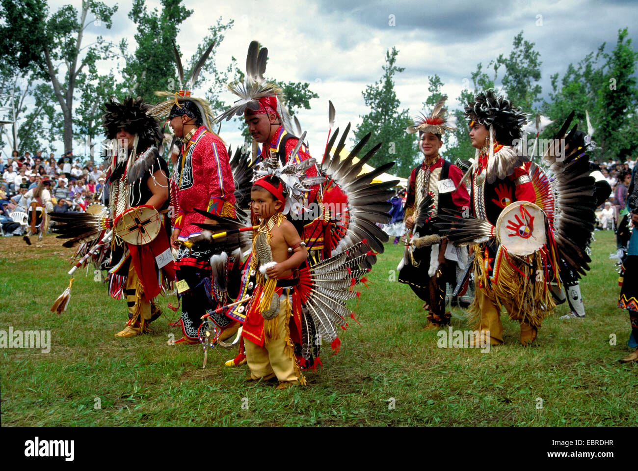 mohicans with headdress of feathers, cultural dress and face painting at the pow wow in the Kahnawake reservation, Canada, Queebec, Montreal Stock Photo