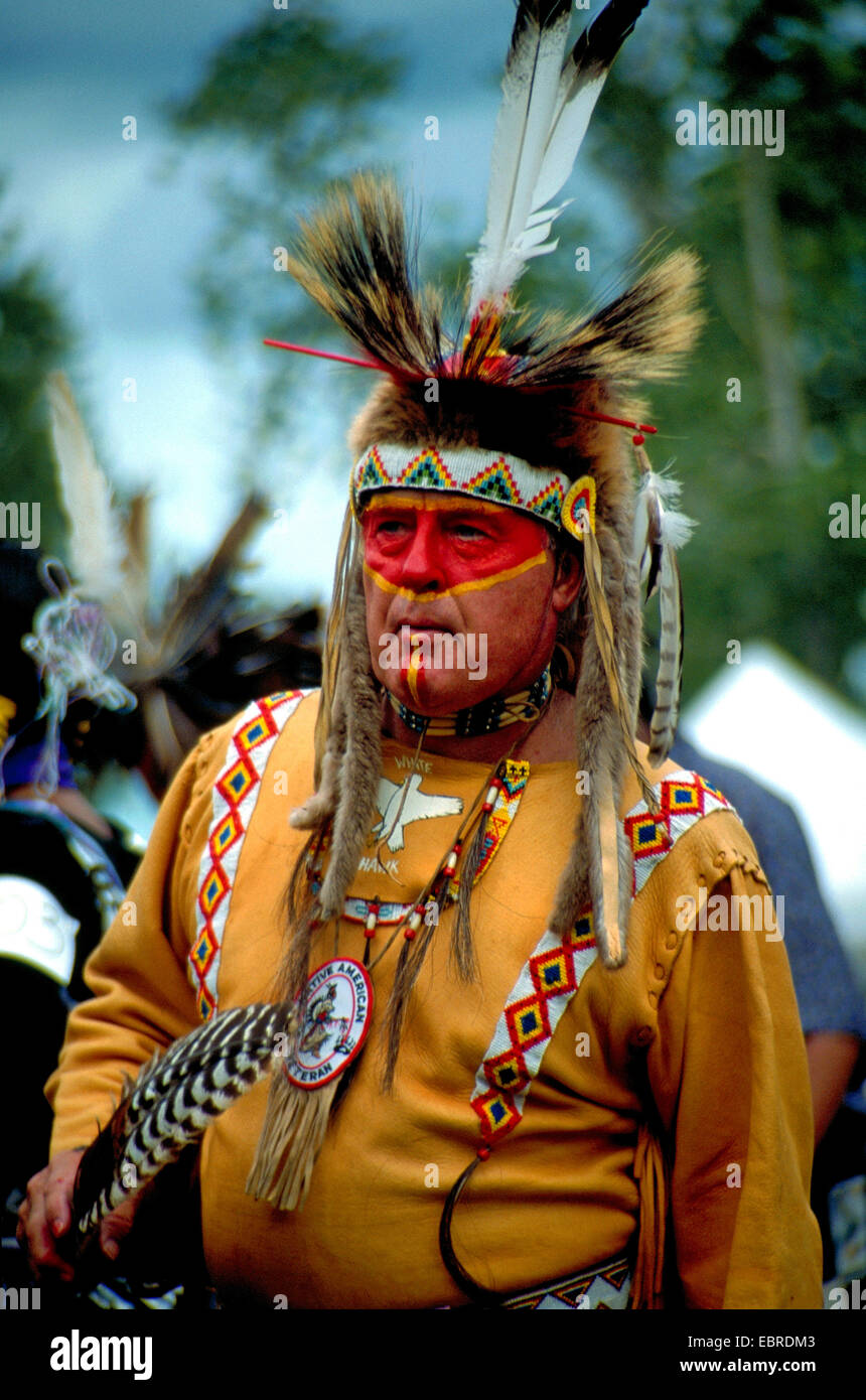 mohican with typical headdress of feathers and face painting at the pow wow in the Kahnawake reservation, Canada, Queebec, Montreal Stock Photo