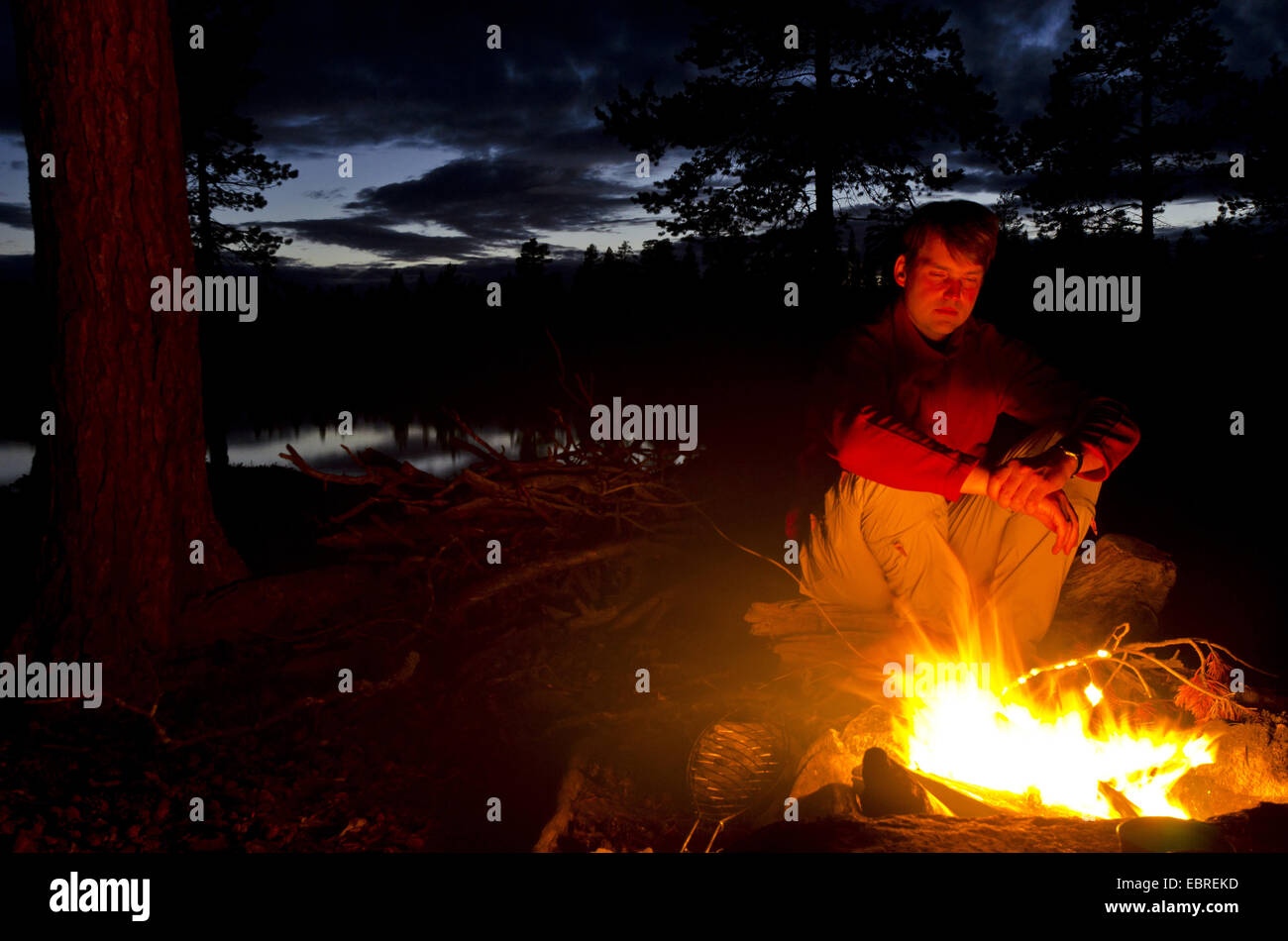 man at campfire, Sweden, Haerjedalen, Rogen Naturreservat Stock Photo