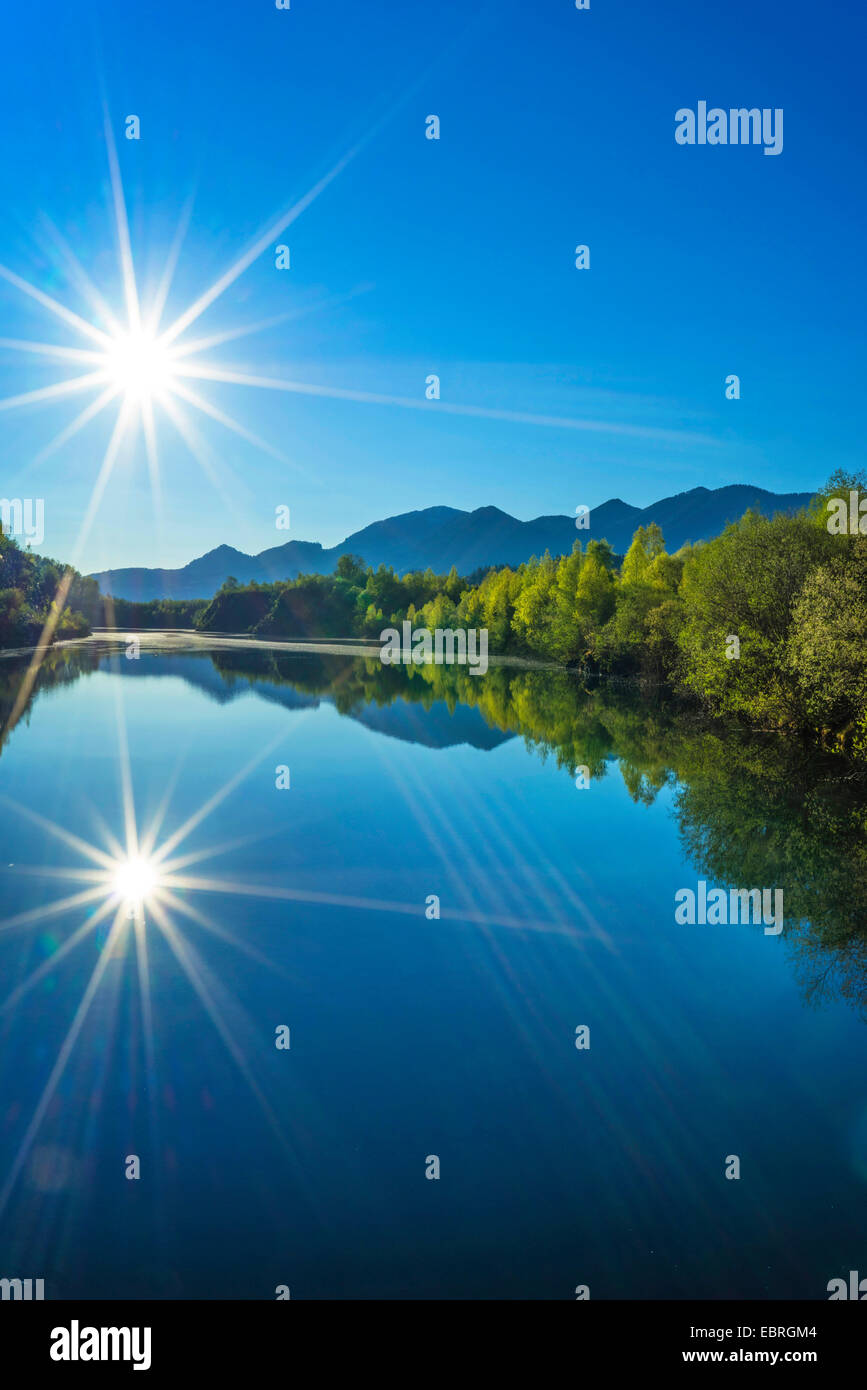 sun mirrors on the Langer Kochelsee at the Murnauer Moos, in the background the Kocheler Mountains, Germany, Bavaria, Oberbayern, Upper Bavaria Stock Photo