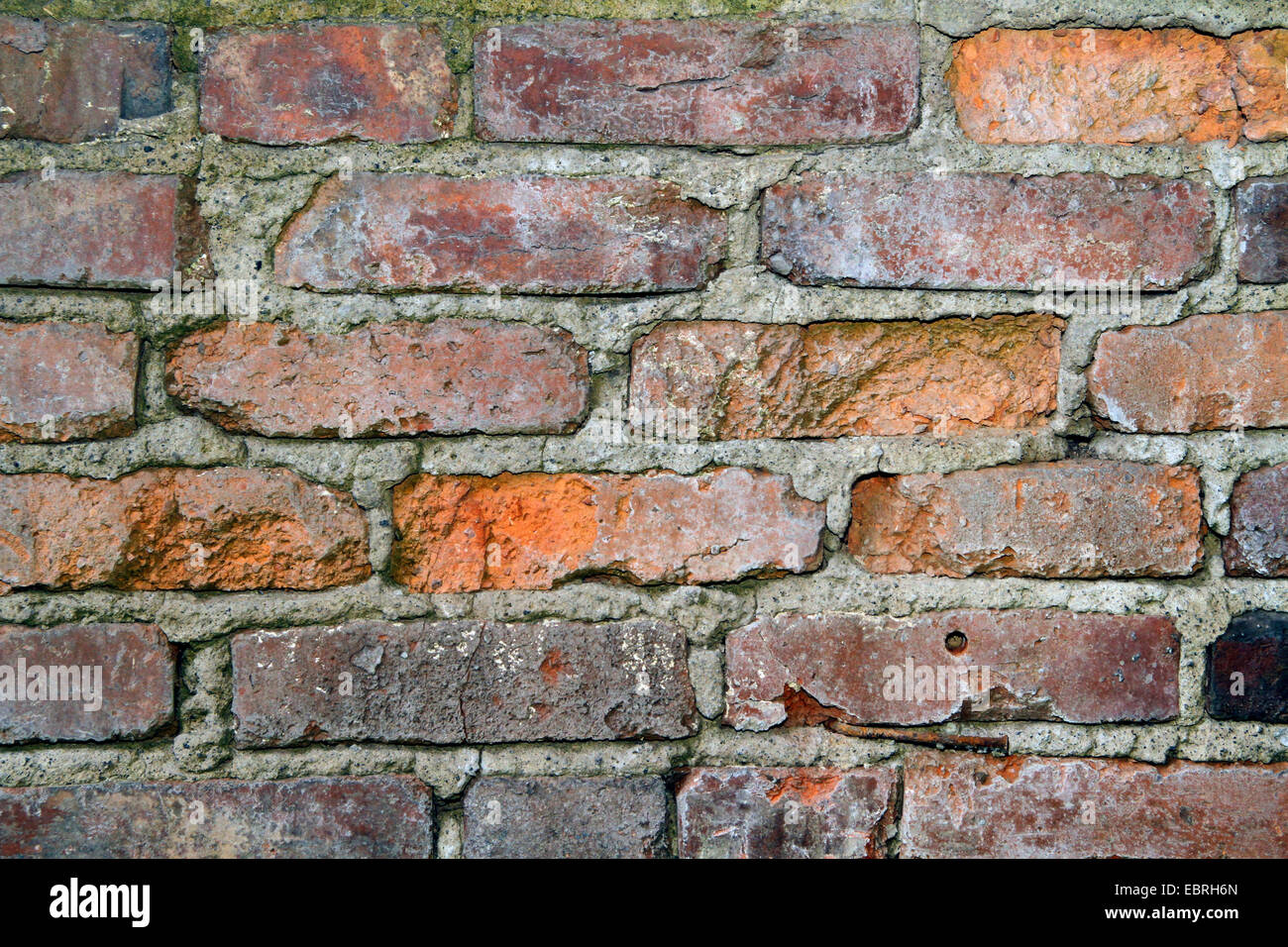 section of a weathered red brick wall, Germany Stock Photo