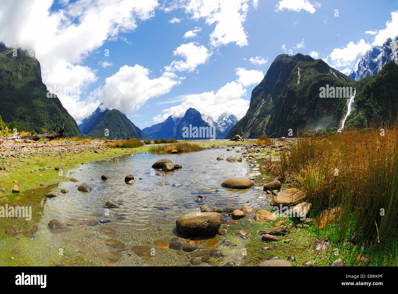 panoramic view through the Milford Sound (Piopiotahi) with the Bowen Falls at the right, New Zealand, Southern Island, Fjordland National Park Stock Photo