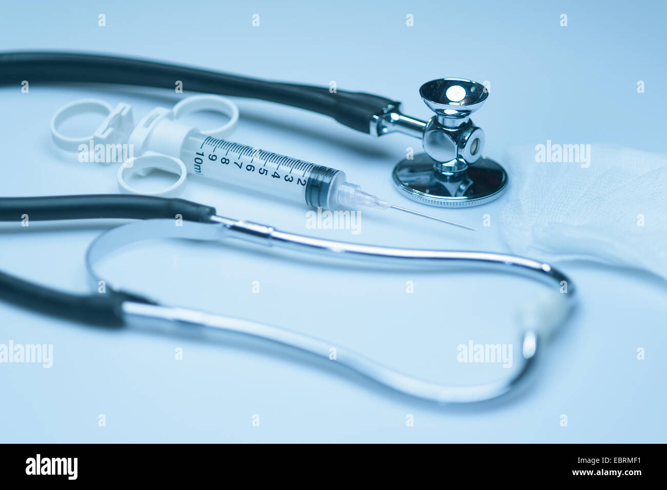 Doctor's medical tools consisting of syringe and stethoscope Stock Photo