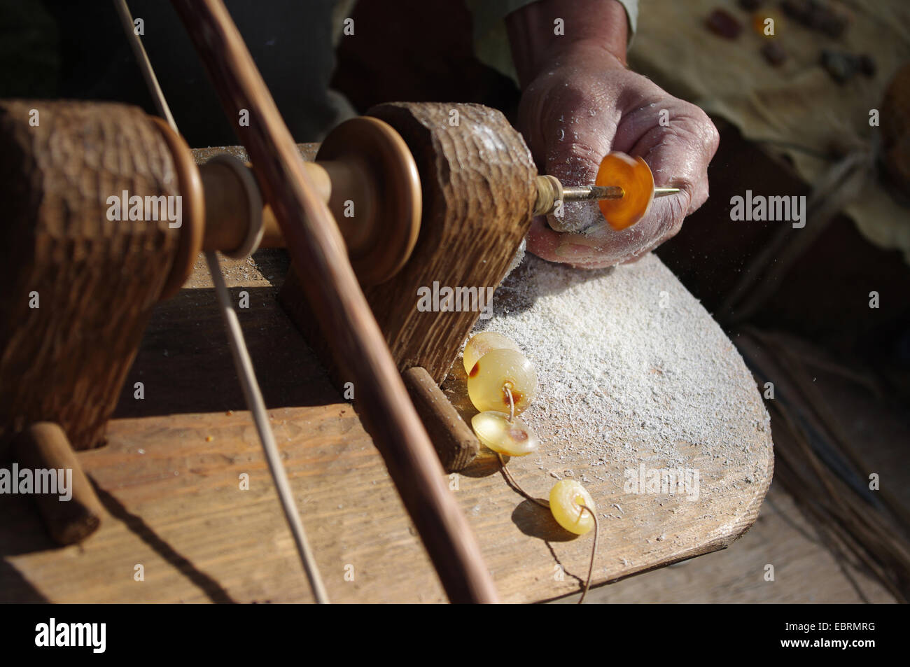 Traditional production of pieces of amber jewelry Stock Photo