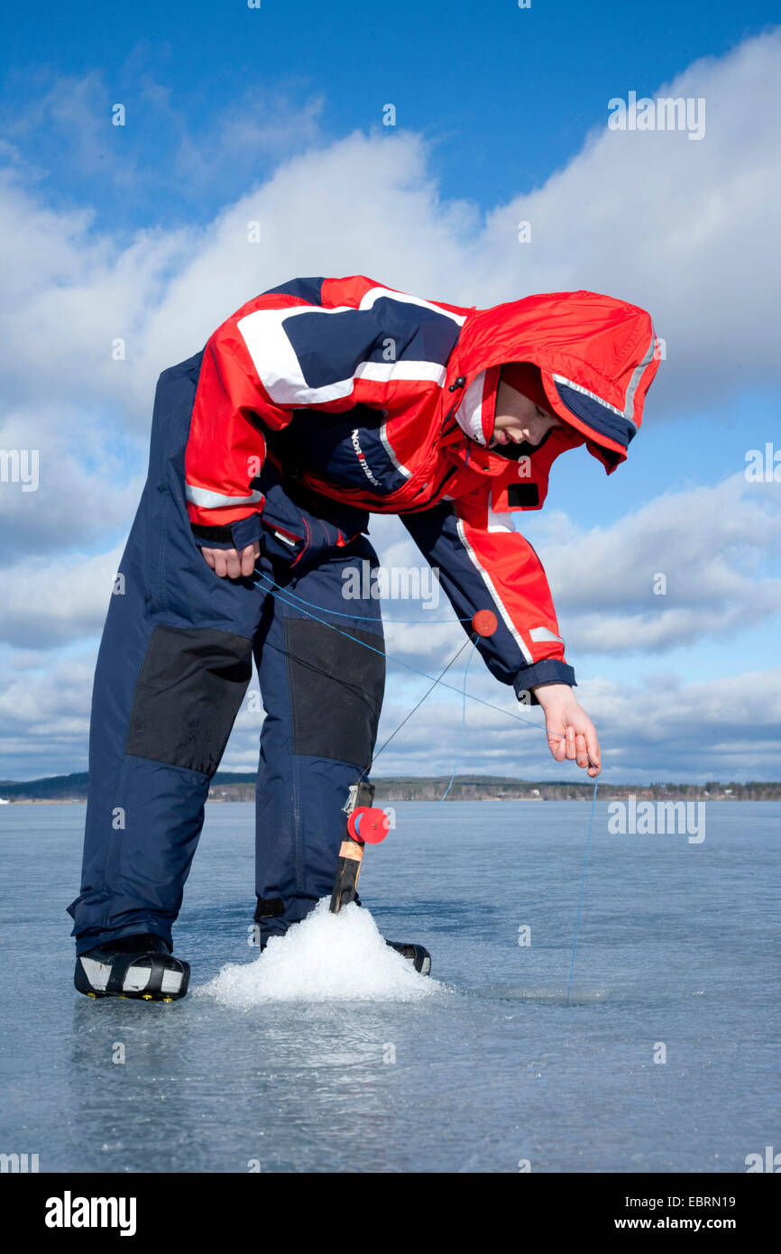 Ice fishing on a freshwater lake, Sweden Stock Photo