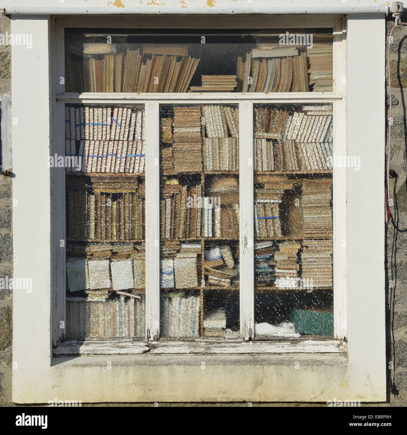 insight through a window, blocked with books, Used bookstore, France, Brittany, Plurien Stock Photo