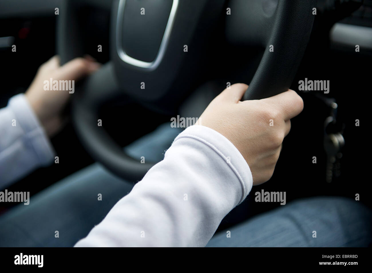 motorist with hand at the steering wheel Stock Photo