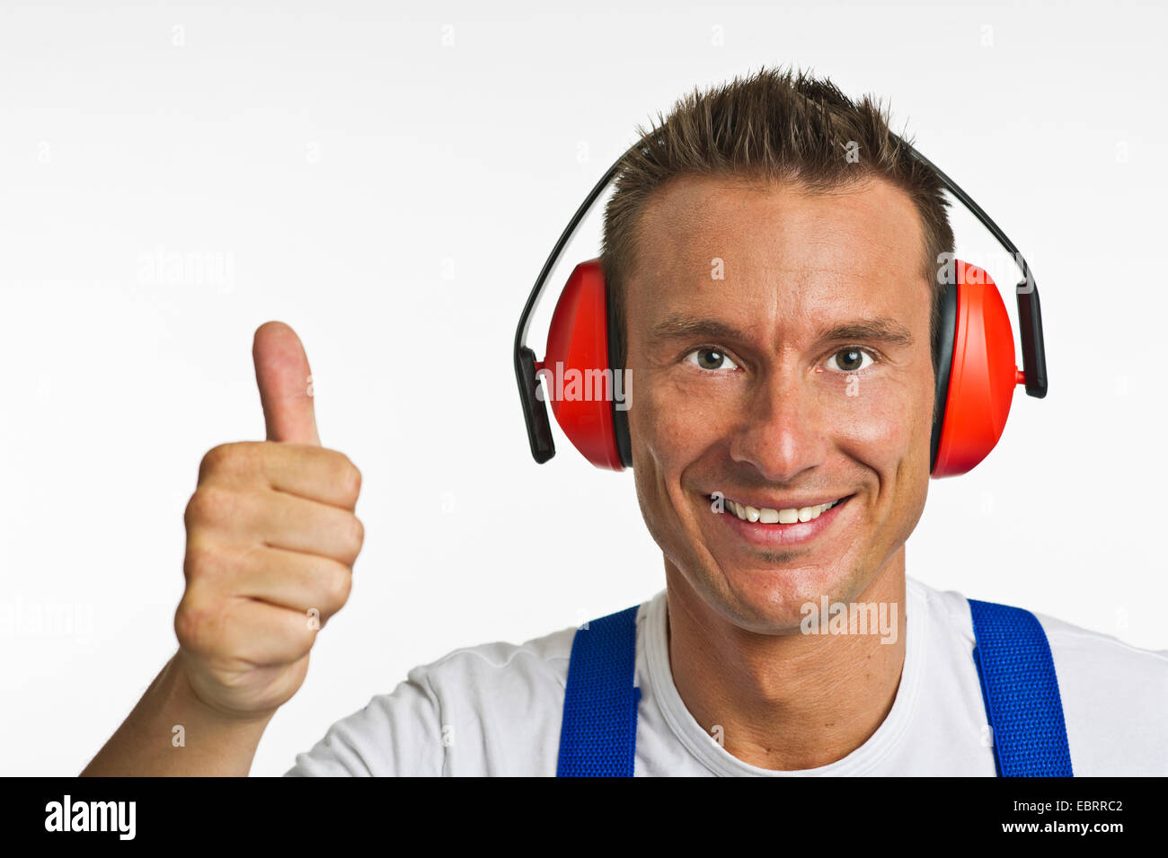 craftsman with ear protection is thumping up Stock Photo