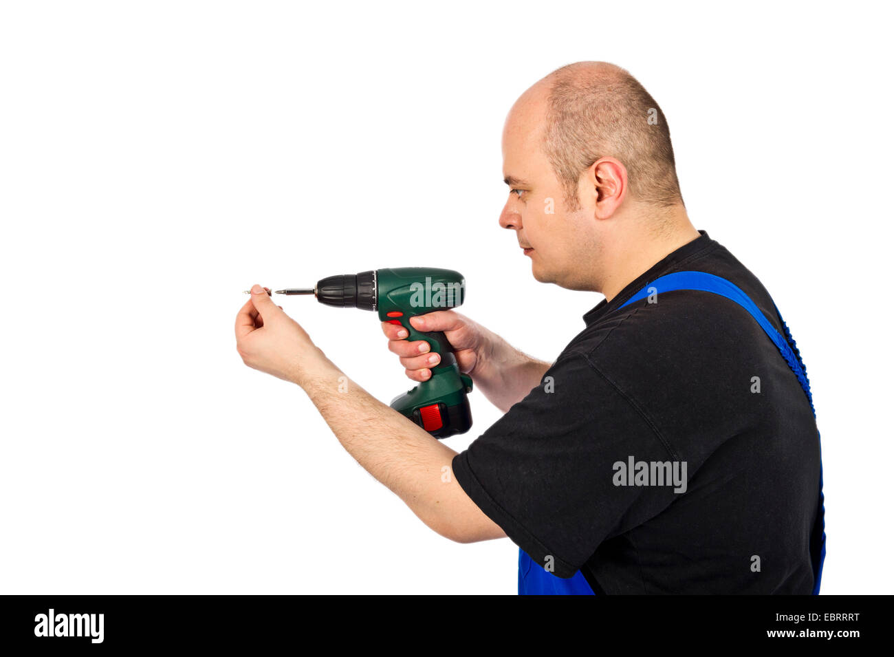 craftsman with cordless screwdriver screwing a screw Stock Photo