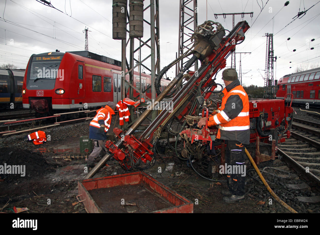 railroad workers during test drillings in the roadbed at 30th Nov. 2013 to figure out if there are further former coal adits in the area of the main railway station, Germany, North Rhine-Westphalia, Ruhr Area, Essen Stock Photo