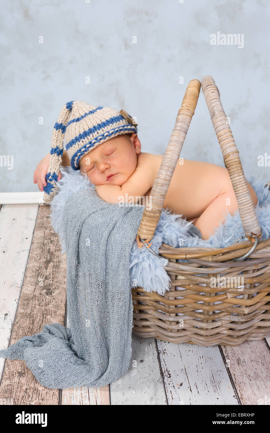 Adorable seven days old newborn baby boy in a wicker basket Stock Photo -  Alamy