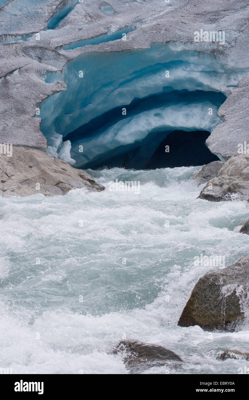 melt water leaking out of glacier snout of Nigardsbreen, a glacier arm of Jostedalsbreen glacier, Norway, Jostedalsbreen National Park Stock Photo