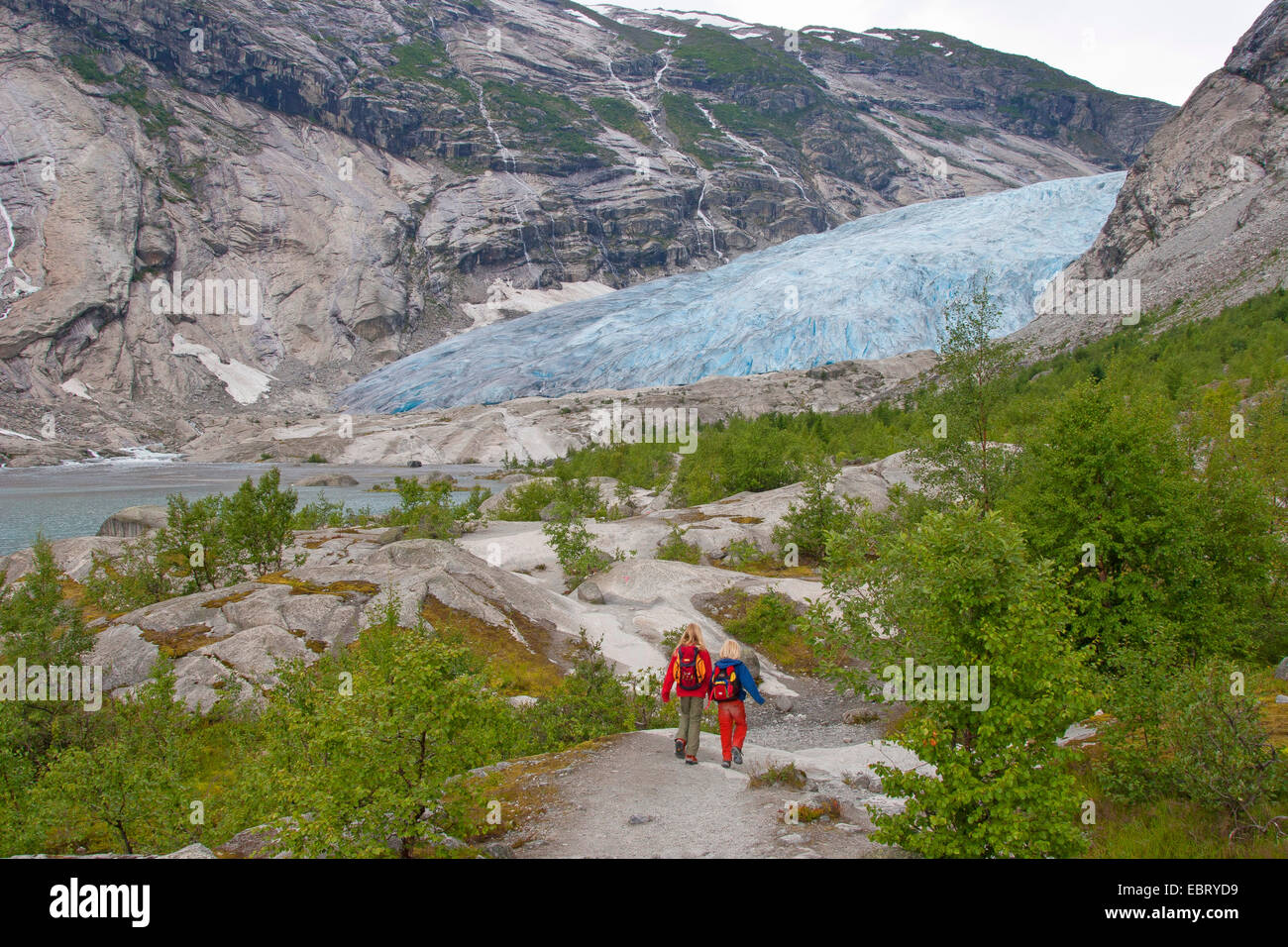 two children wandering to Nigardsbreen glacier arm, Norway, Jostedalsbreen National Park Stock Photo