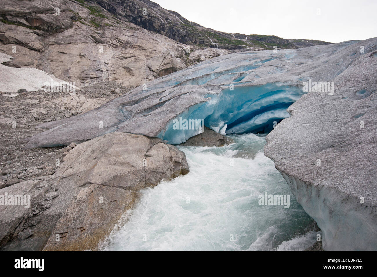 melt water leaking out of glacier snout of Nigardsbreen, a glacier arm of Jostedalsbreen glacier, Norway, Jostedalsbreen National Park Stock Photo